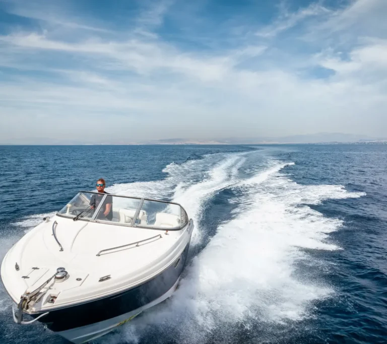 Speedboat leaving foamy wake on blue sea
